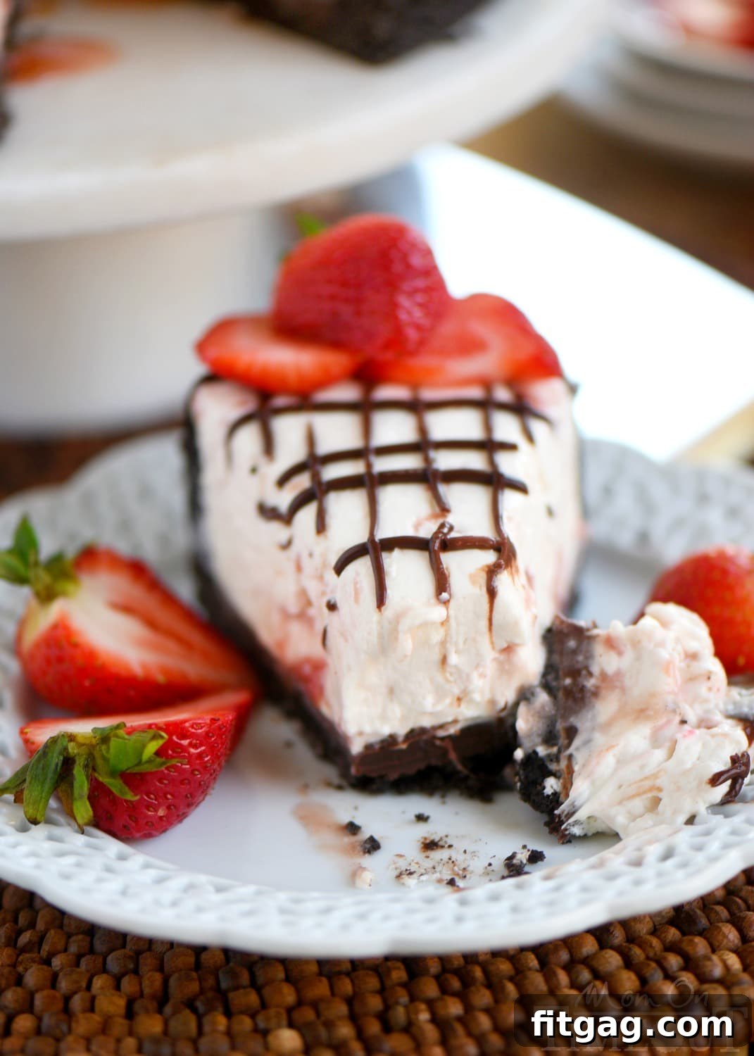 Strawberry Cloud Cheesecake 8 Close-up of a serving of No-Bake Strawberry Cheesecake on a plate, showing its creamy texture and strawberry goodness.