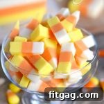 No-Bake Candy Corn Fudge Bliss 4 Easy Candy Corn Fudge squares arranged on a platter, showcasing the distinct yellow, orange, and white layers.