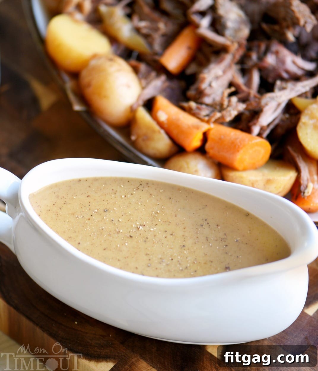 A gleaming gravy boat filled with rich, homemade pot roast gravy, ready to be poured over dinner.
