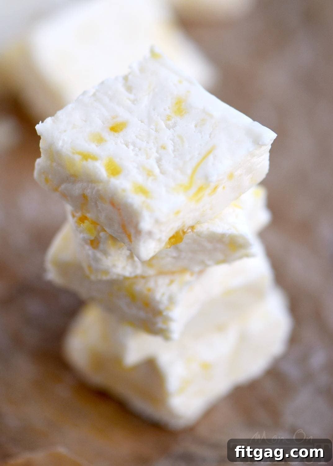 Tropical Pineapple Fudge Bliss 3 A close-up of a perfectly cut square of Pineapple Fudge, revealing its creamy texture and the subtle speckles of crushed pineapple, promising a delightful blend of tropical sweetness and rich indulgence. This is homemade fudge at its finest. // Mom On Timeout
