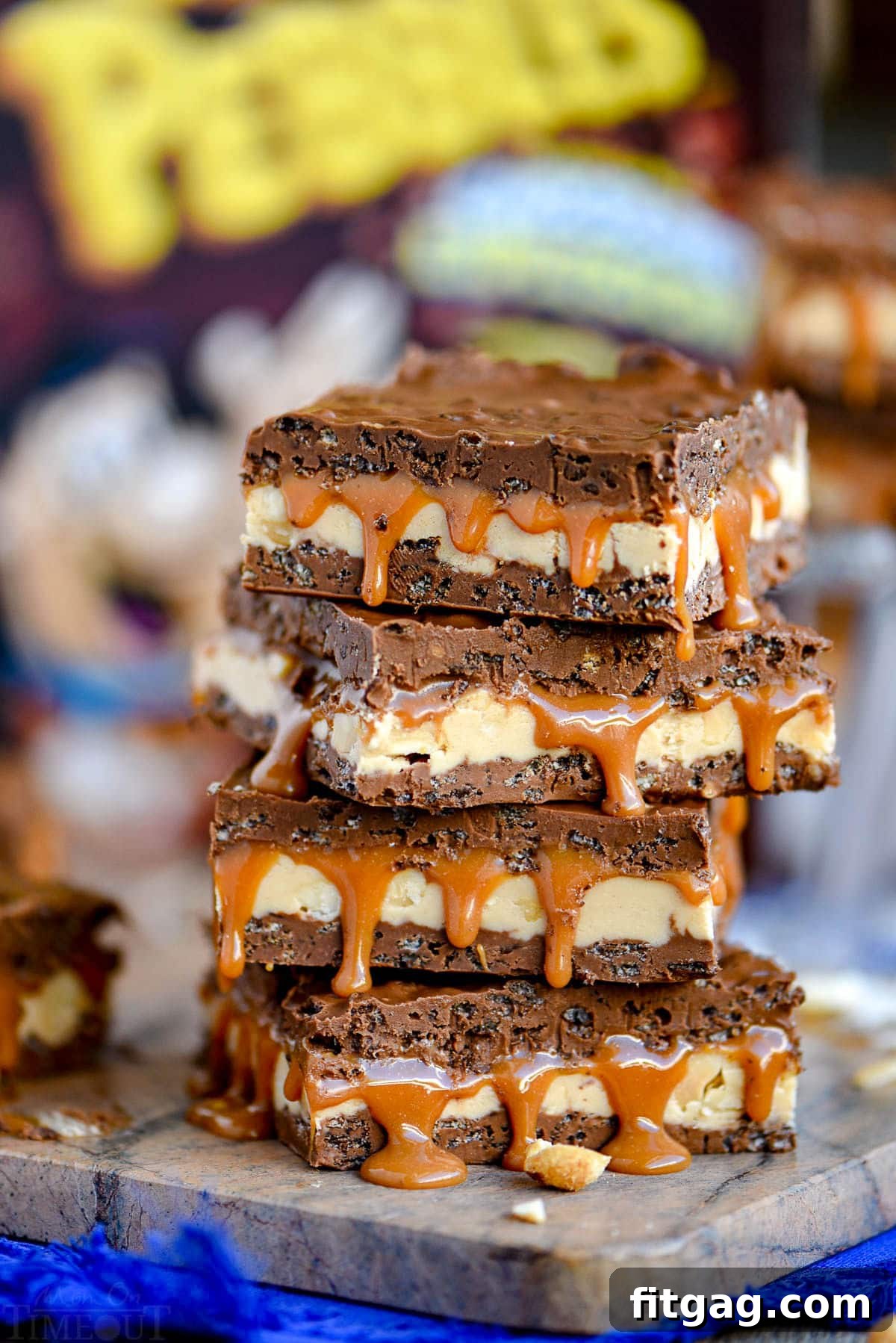 snickers bars sitting in front of a cereal box on a brown marble cutting board.