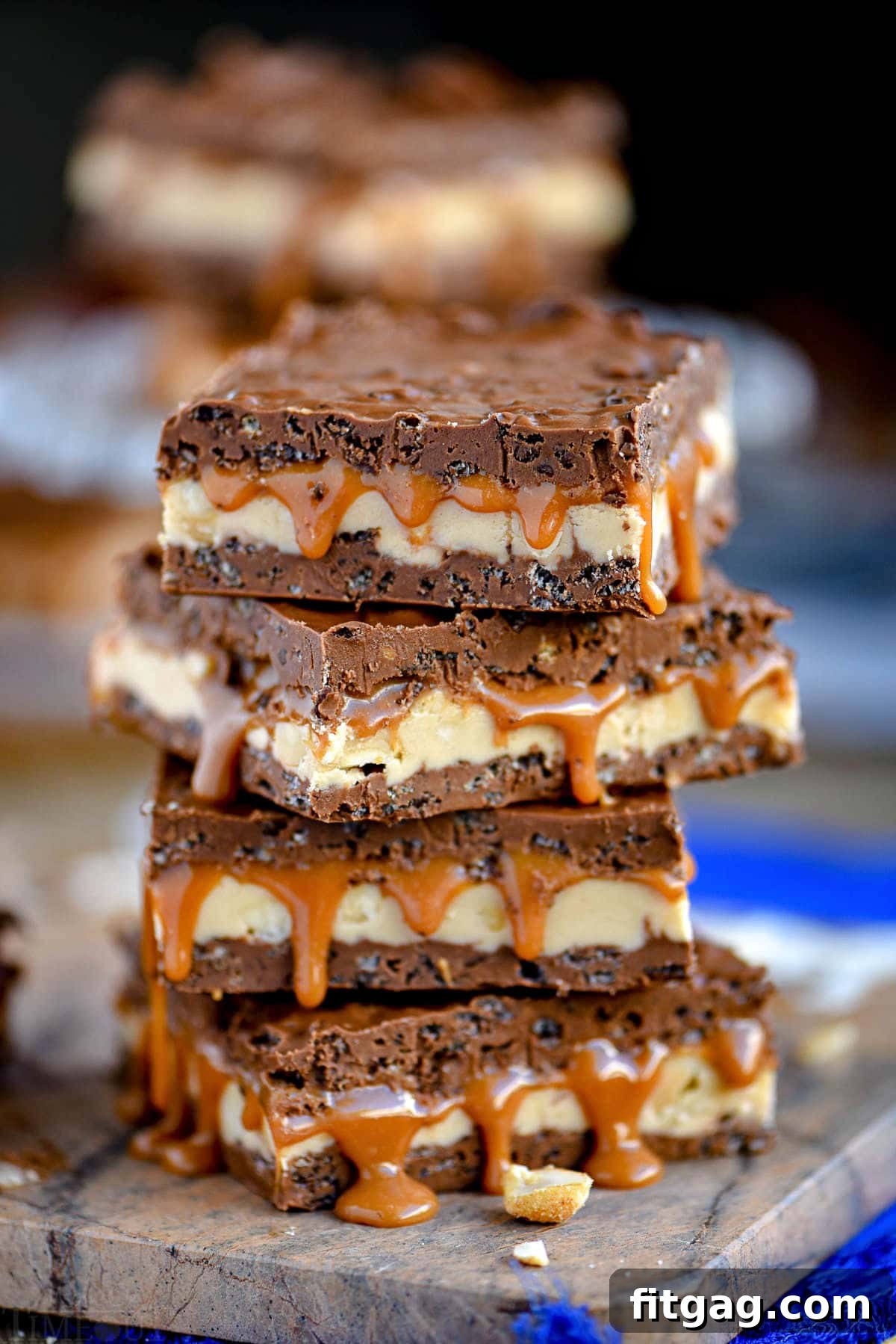 caramel nougat snickers bars stacked on each other, four high.