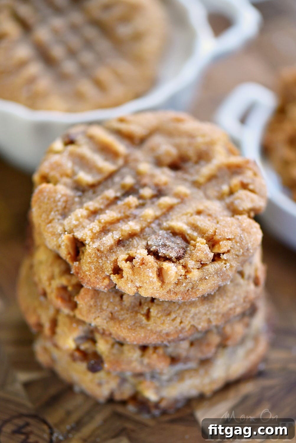 A close-up of a single Flourless Toffee Peanut Butter Cookie, showcasing its rich texture and toffee inclusions.