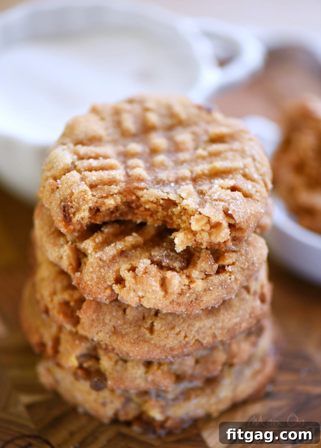 A perfectly baked Flourless Toffee Peanut Butter Cookie with the classic fork marks and visible toffee pieces.