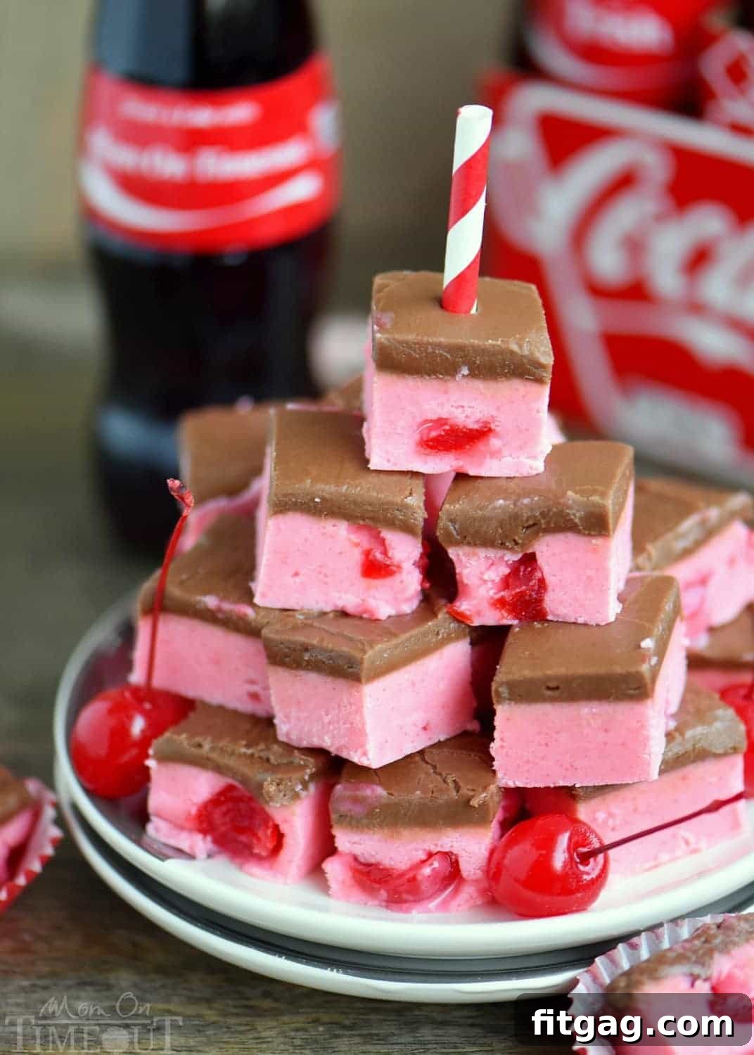 Hand holding a slice of Cherry Coke Fudge, highlighting its layers and texture