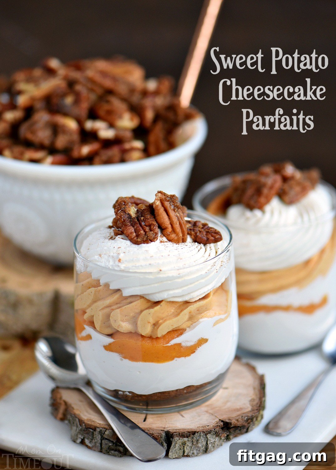 Two elegant glasses of Sweet Potato Cheesecake Parfaits, showcasing layers of gingersnap cookies, marshmallow, sweet potato cheesecake, and whipped cream, topped with candied pecans and a dash of cinnamon.