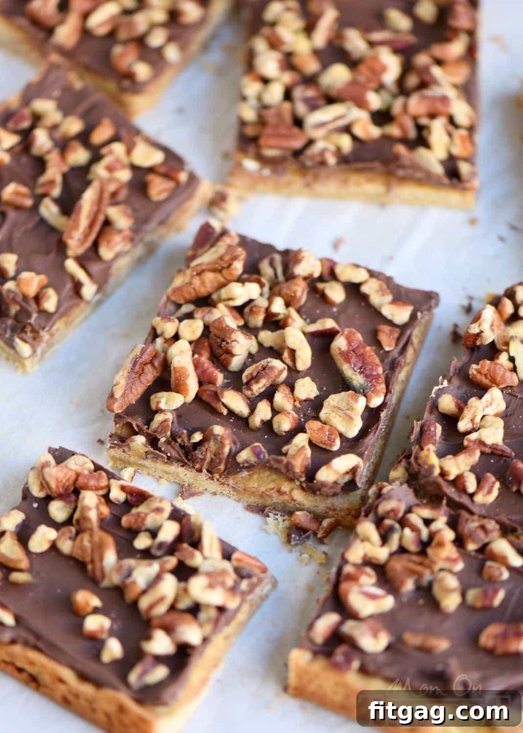 Close-up of freshly baked Easy Toffee Bars with melted milk chocolate and chopped pecans.