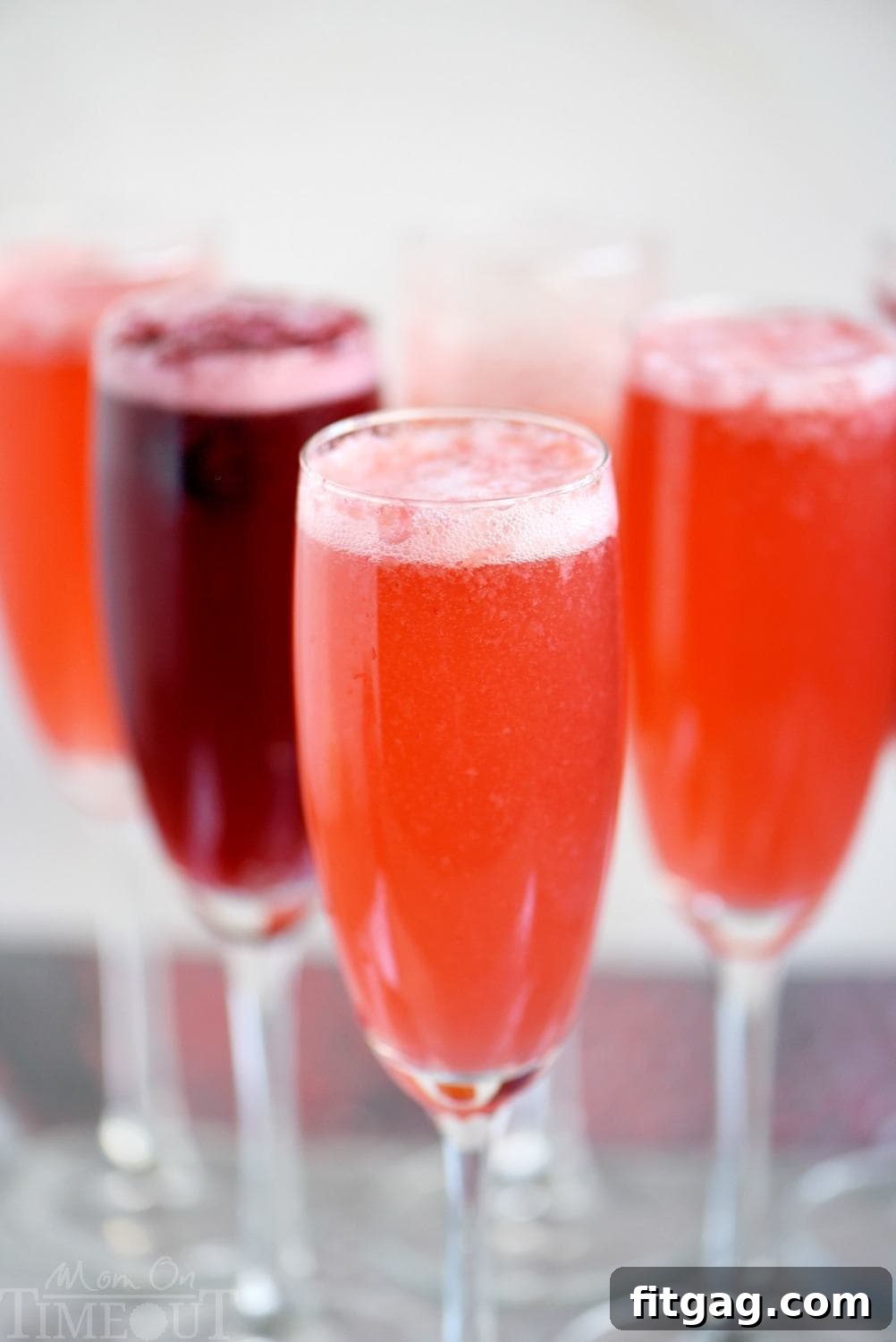 Berry Champagne Punch is assembled by combining berry puree, sparkling wine, and a splash of lemon-lime soda for a sweet, bubbly, and colorful party drink.
