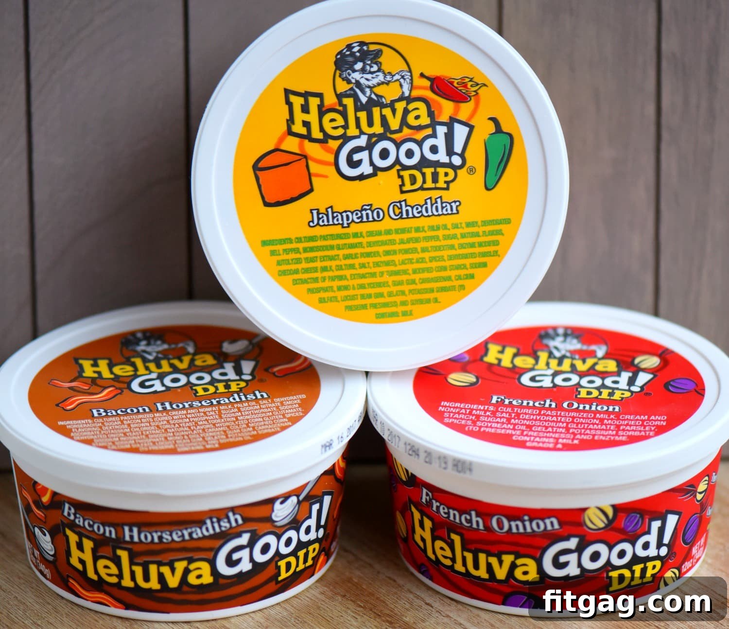 A close-up shot of a variety of Heluva Good! Dips, highlighting their creamy texture and vibrant flavors, surrounded by game day snacks.
