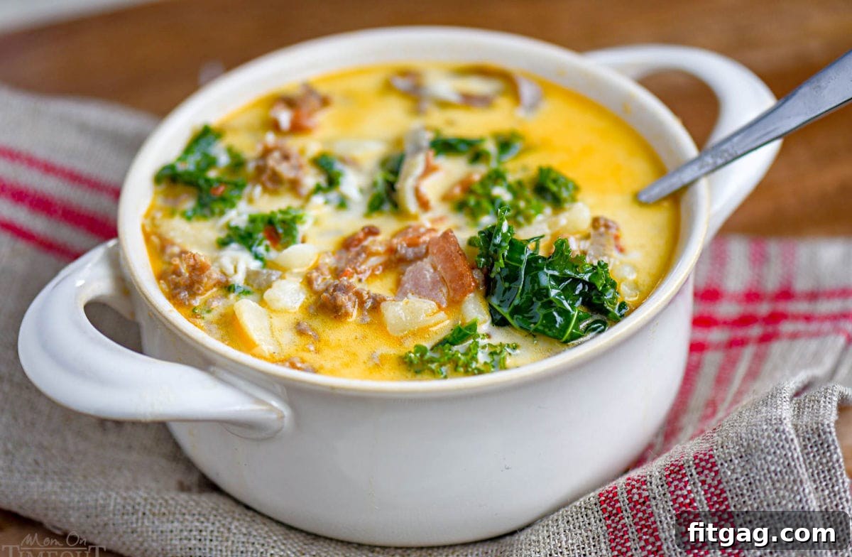 Hearty Tuscan Farmhouse Soup 5 White bowl with handles filled with creamy Zuppa Toscana soup, generously topped with grated Parmesan cheese. Visible ingredients include vibrant green kale, savory sausage, and crispy bacon.
