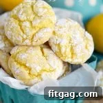 Zesty Lemon Snaps 5 A small green basket filled with baked lemon cookies, garnished with lemon slices and fresh mint, illustrating their delicious freshness.