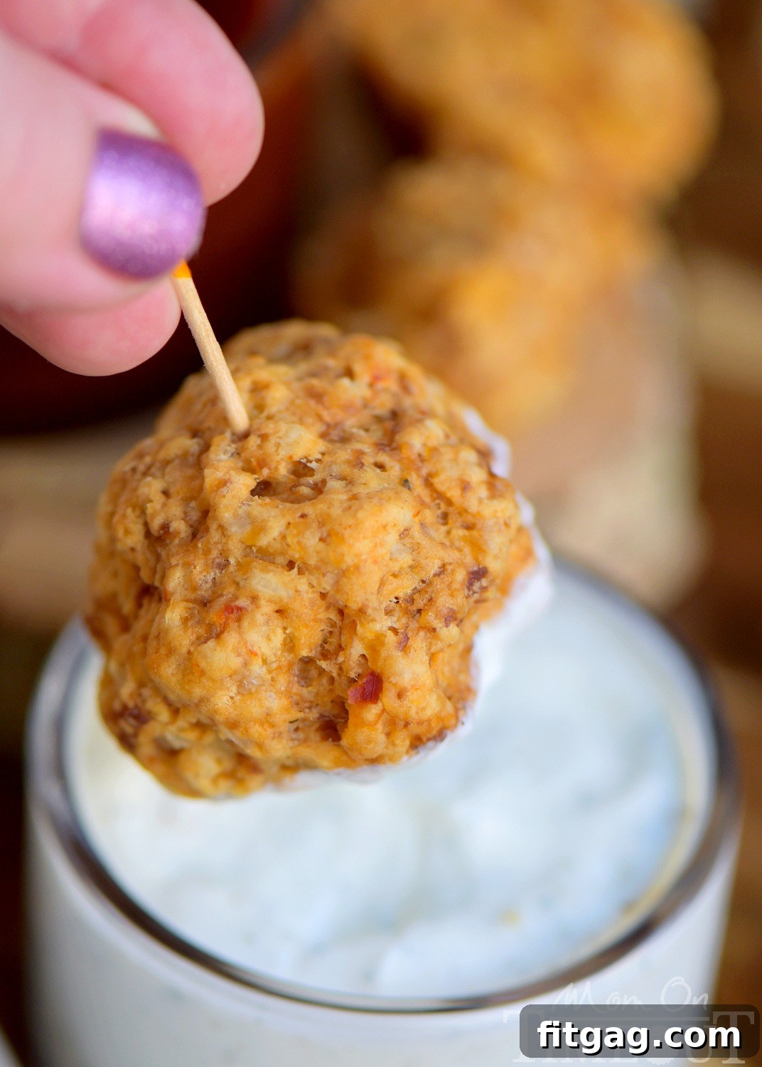 A close-up of a platter of freshly baked sausage cheese balls, ready to be served.