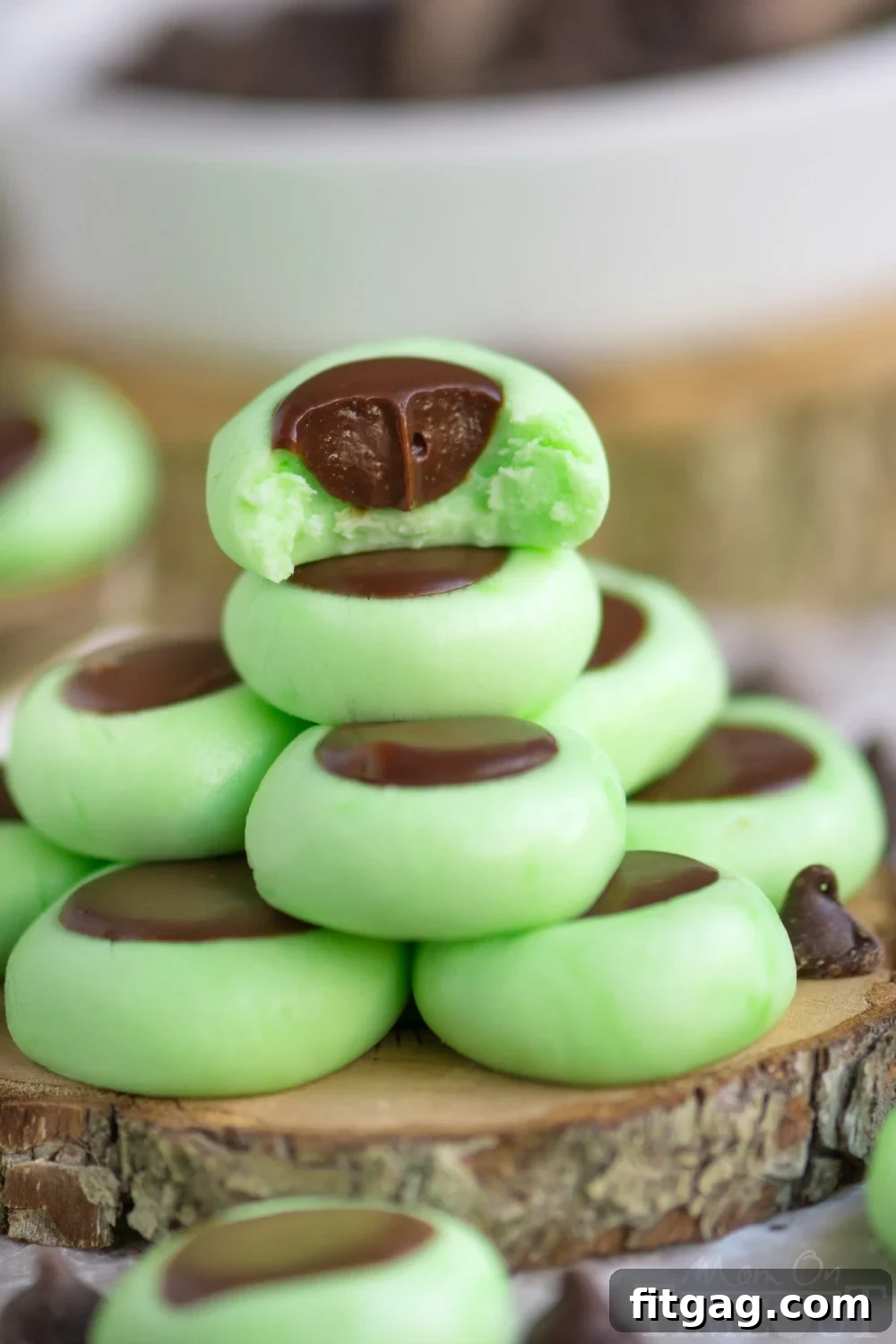 Minty Chocolate Cream Cheese Gems 4 A close-up of a finished Chocolate Mint Cream Cheese Button, showcasing its smooth green exterior and a perfectly piped chocolate ganache center.
