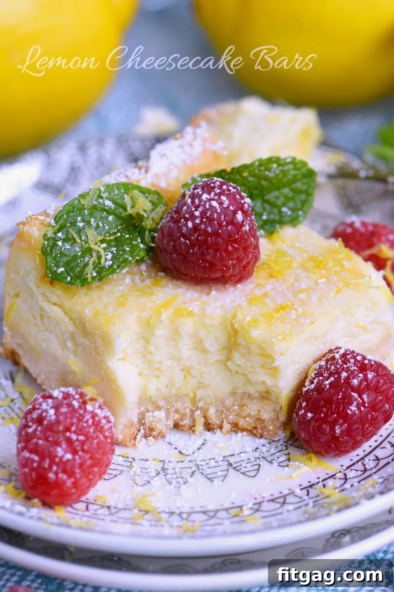 Zesty Lemon Cheesecake Bars 2 My Aunt Pam's Lemon Cheesecake Bars are made with lots of fresh lemon juice and zest so they're bursting with lemon flavor! Extra creamy, super easy and always a crowd pleaser! Top with powdered sugar, fresh raspberries, and extra lemon zest for a pretty presentation! // Mom On Timeout