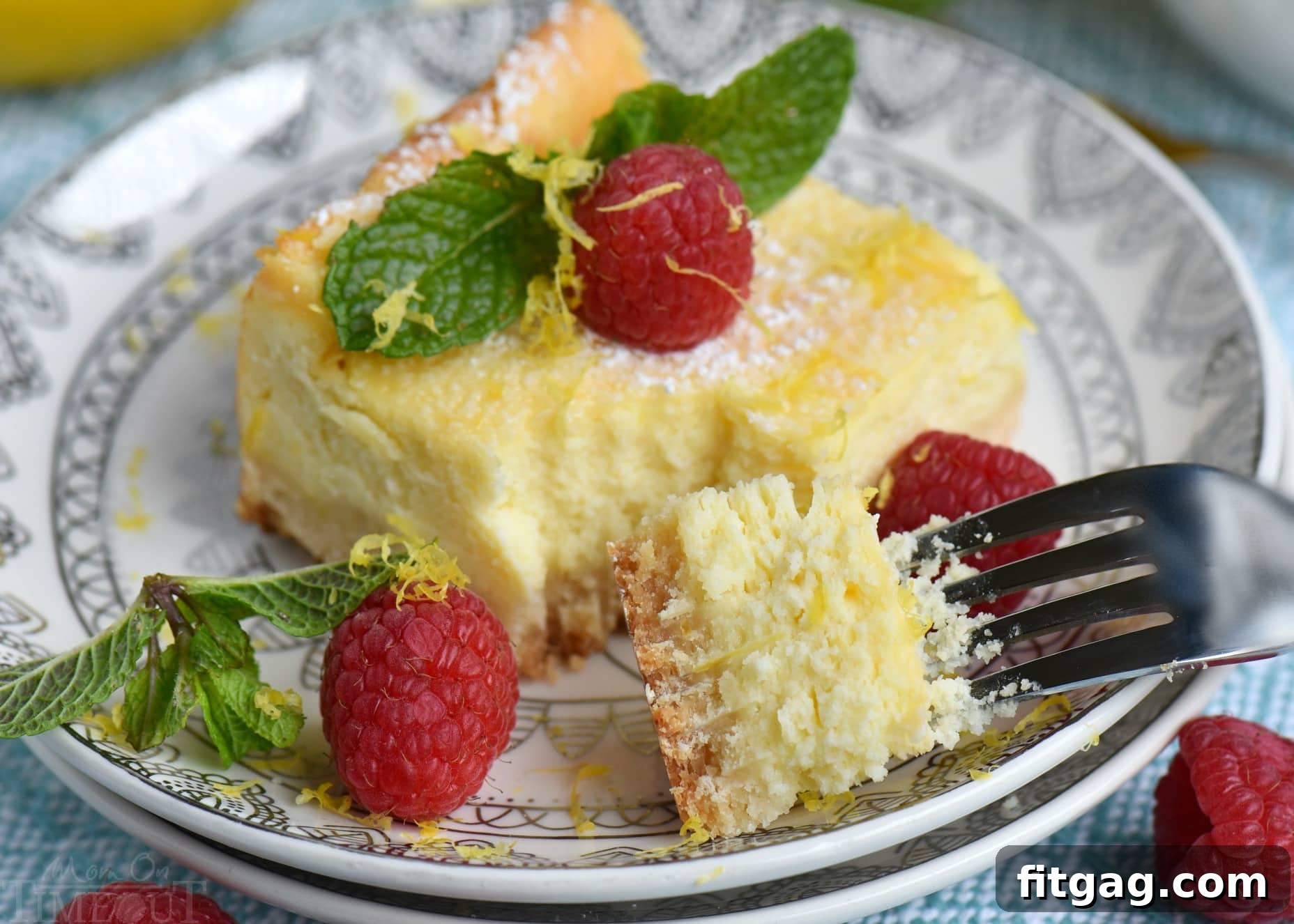 Zesty Lemon Cheesecake Bars 3 My Aunt Pam's Lemon Cheesecake Bars are made with lots of fresh lemon juice and zest so they're bursting with lemon flavor! Extra creamy, super easy and always a crowd pleaser! Top with powdered sugar, fresh raspberries, and extra lemon zest for a pretty presentation! // Mom On Timeout