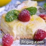 Zesty Lemon Cheesecake Bars 5 Aunt Pam's Lemon Cheesecake Bars - A vibrant, creamy dessert with a lemon-infused crust and tangy cheesecake filling, perfect for any occasion. Topped with powdered sugar and fresh raspberries.