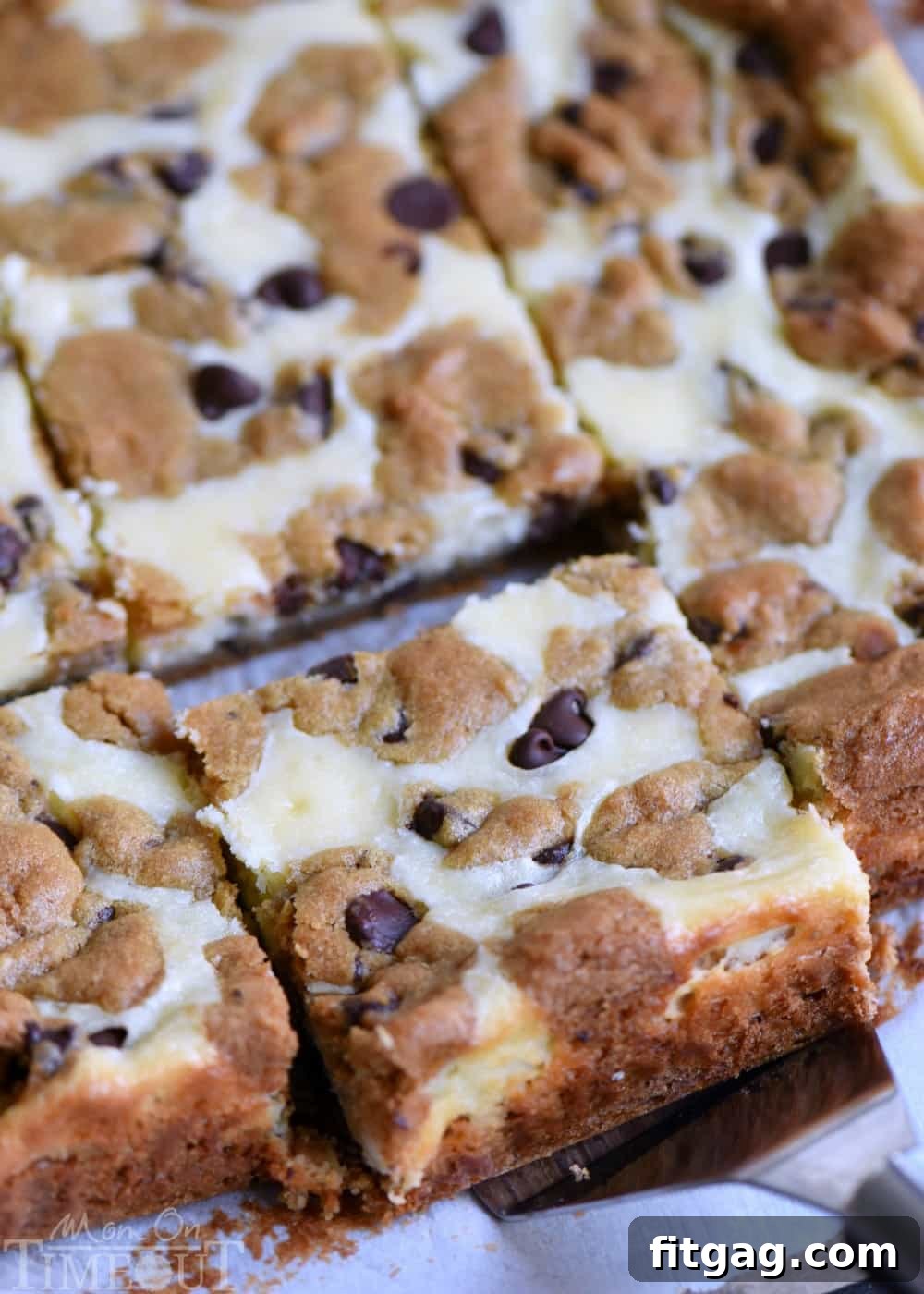 Ultimate Chocolate Chip Cookie Cheesecake Bars 2 Close-up of freshly baked Chocolate Chip Cookie Cheesecake Bars, highlighting the creamy cheesecake and cookie layers