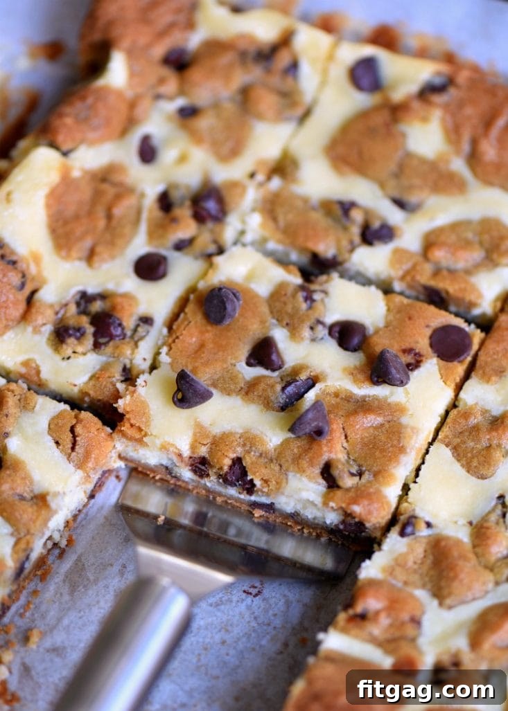 Easy 5-ingredient Chocolate Chip Cookie Cheesecake Bars: perfect for any occasion and every craving. Serving individual slices of Chocolate Chip Cookie Cheesecake Bars on a plate