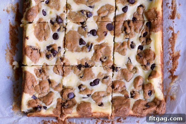 Making easy Chocolate Chip Cookie Cheesecake Bars for parties, bake sales, and sweet cravings. Parchment paper lining a baking pan for Chocolate Chip Cookie Cheesecake Bars