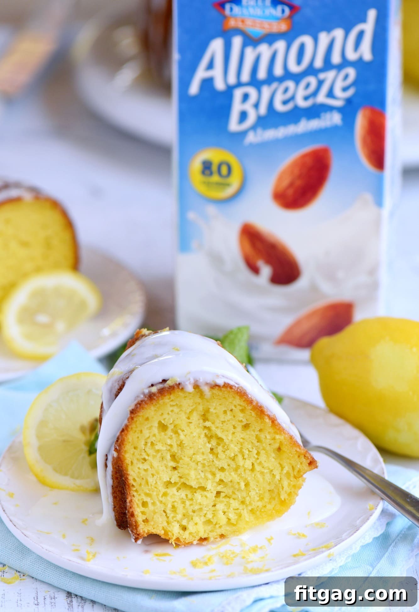 Golden Lemon Bundt Bliss 5 A generous slice of Easy Lemon Bundt Cake on a plate, garnished with fresh lemon slices and mint leaves, ready to be enjoyed.