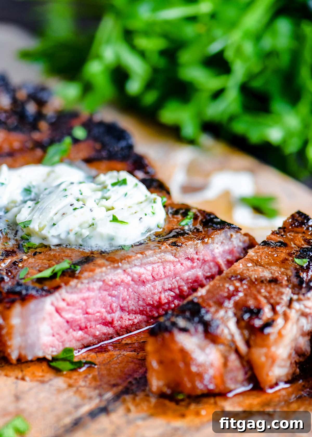 The Ultimate Steak Marinade 4 A perfectly cooked steak on a cutting board, topped with melting compound butter and garnished with fresh parsley, ready to be enjoyed.