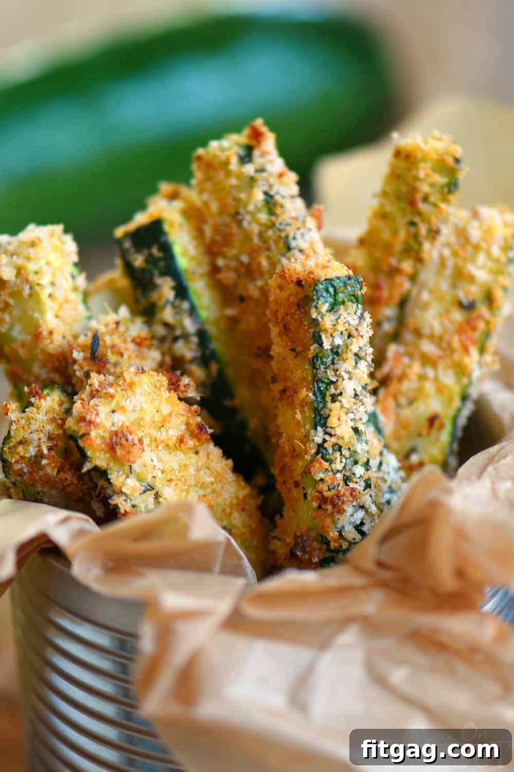Crispy Parmesan Zucchini Sticks 6 Variety of Baked Parmesan Zucchini Fries arranged on a rustic wooden board