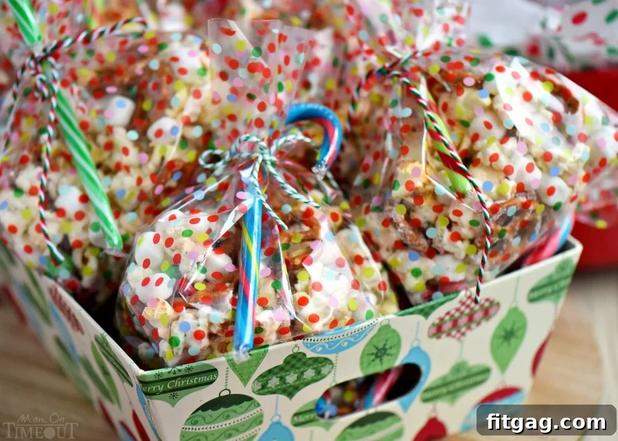 Festive Snow Day Snack Mix in a large serving bowl, ready for Christmas parties. A sweet and salty blend of popcorn, pretzels, M&M's, marshmallows, and sprinkles.