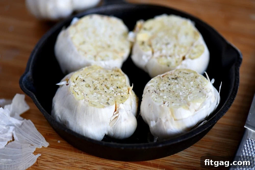 Perfect Roasted Garlic Made Easy 3 Fresh garlic heads with the tops sliced off, ready for roasting.