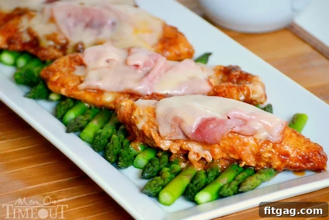 Close-up of golden-brown chicken strips beautifully layered with melted Swiss cheese and savory ham, topped with a luscious cream gravy, demonstrating the mouth-watering appeal of Inside Out Chicken Cordon Bleu.