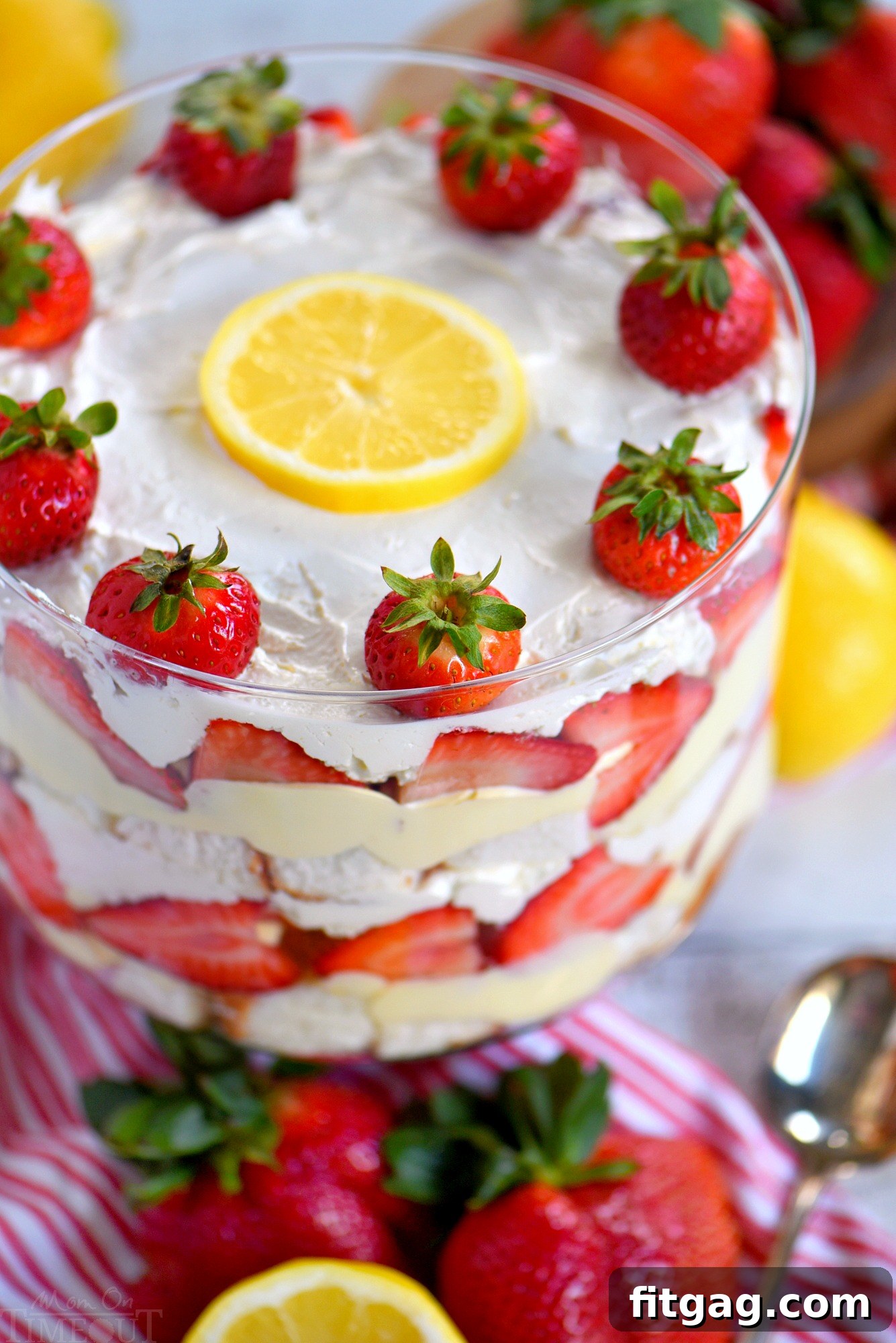This Lemon Strawberry Trifle is what dreams are made of! An easy, no bake trifle recipe that is loaded with fresh strawberries, angel food cake, and lemon pudding - sure to be the highlight of your party! Perfect for easy entertaining during spring and summer! // Mom On Timeout strawberry-trifle
