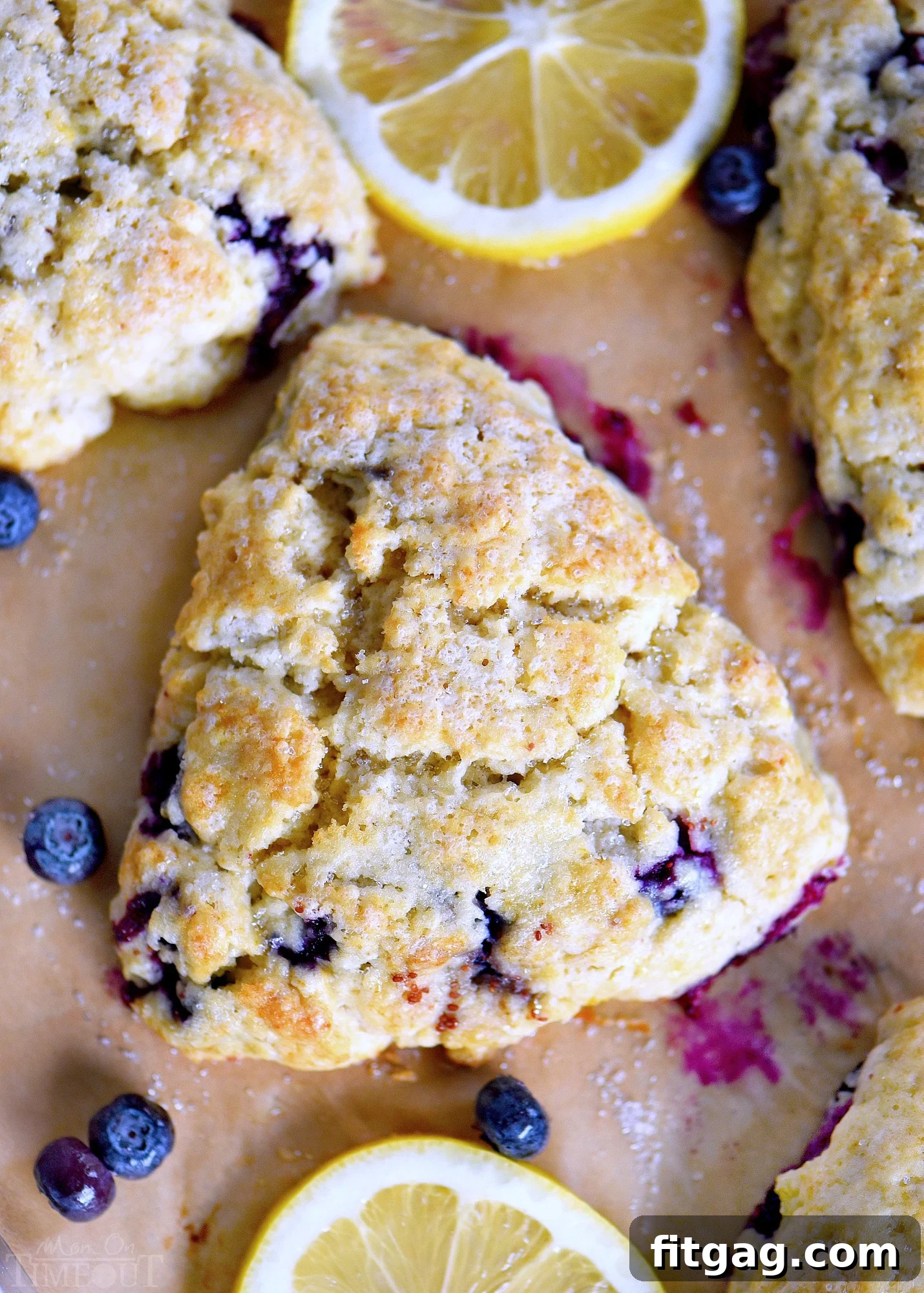 Freshly baked lemon blueberry scones with lemon curd and cream, elegantly arranged for breakfast or afternoon tea