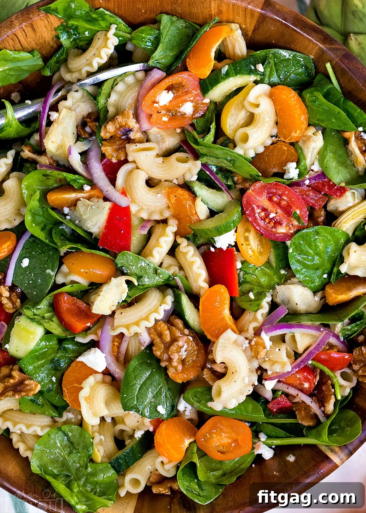 Close-up of Perfect Pasta Salad featuring colorful vegetables, pasta, and feta cheese, ready to be served at a summer event.