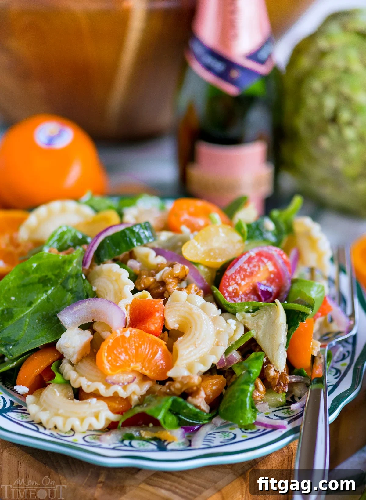 A bowl of fresh Perfect Pasta Salad dressing ingredients: olive oil, mandarin juice, and white wine, ready to be mixed.