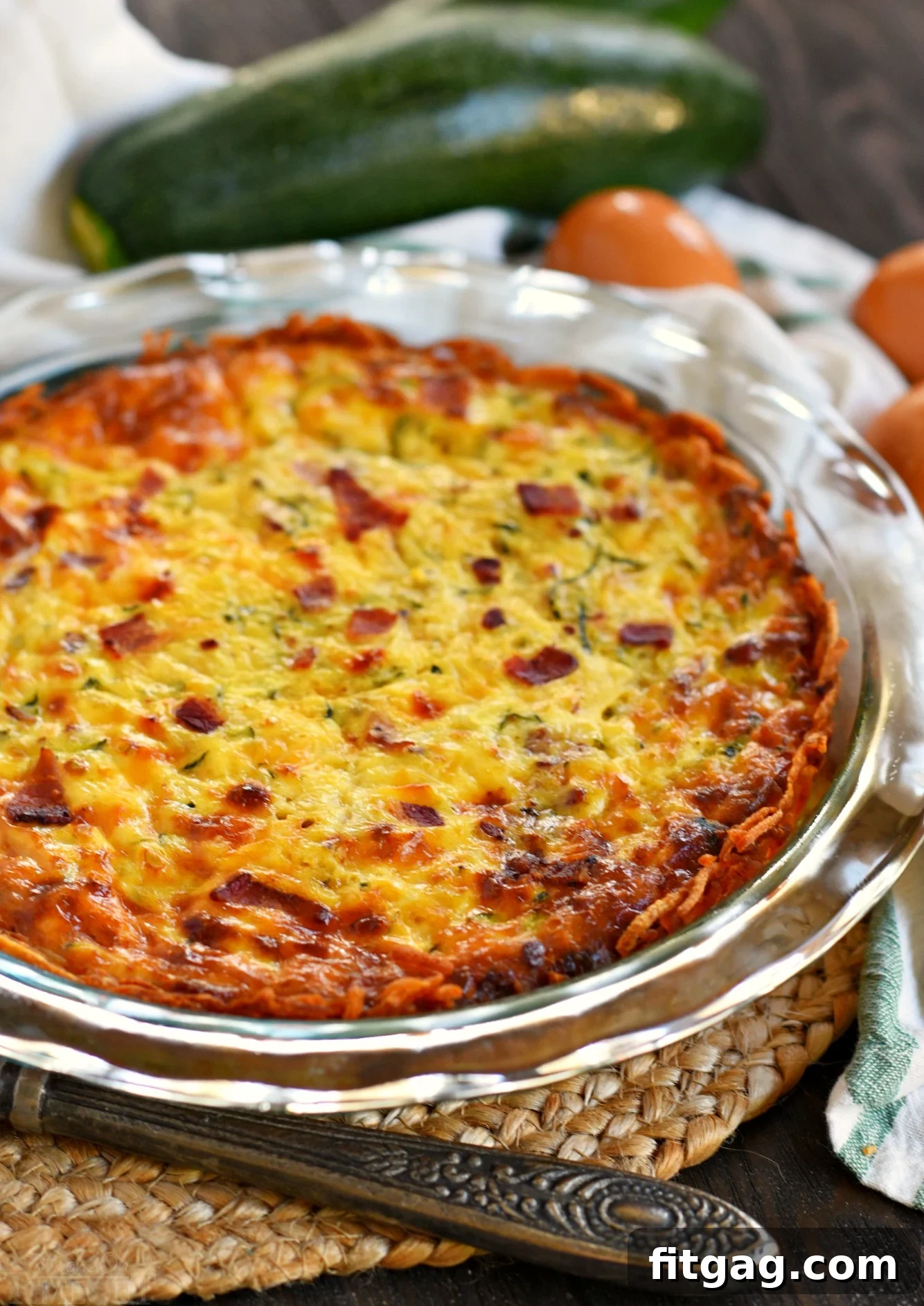 Whole Zucchini Quiche with Bacon and Hash Brown Crust in a pie plate