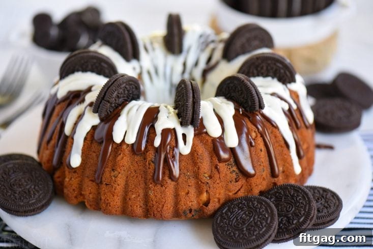 A beautifully decorated Cookies and Cream OREO Cake, topped with both chocolate and white glazes and garnished with whole Oreos.