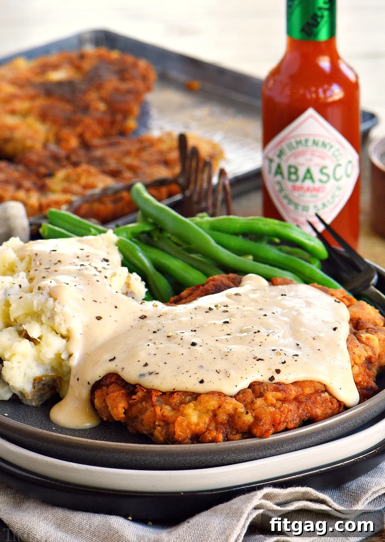 Chicken Fried Steak plated with mashed potatoes and gravy