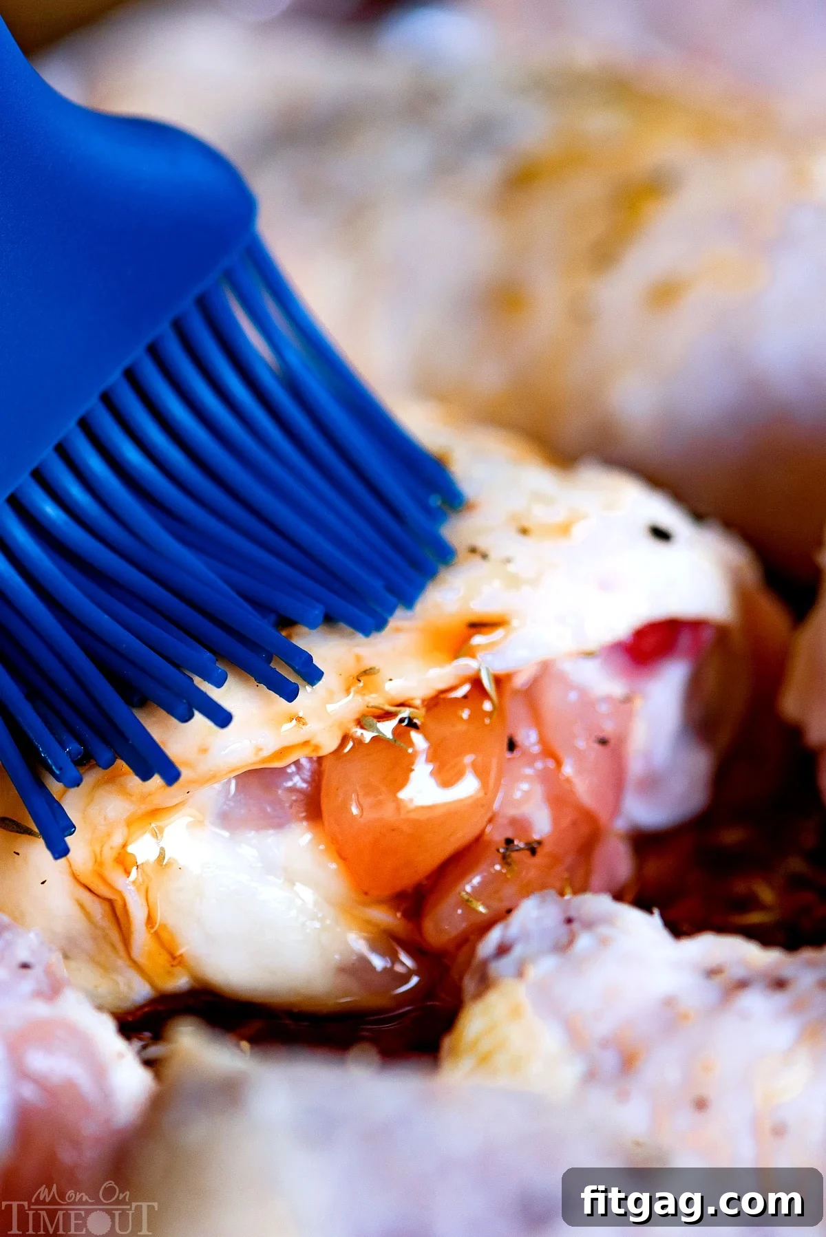 Brushing honey balsamic glaze onto chicken