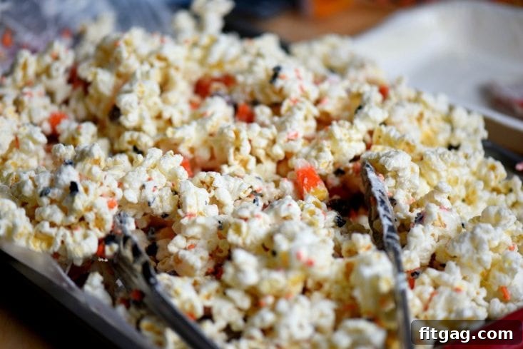 Individual ingredients for Candy Corn Popcorn Munch, including popcorn, candy corn, candy melts, and sprinkles.