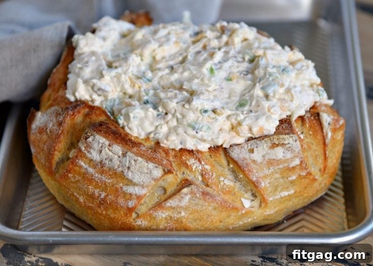 Baked Bacon Cheese Dip - Warm and Bubbly Close-up of Baked Bacon Cheese Dip in a bread bowl, ready for serving.