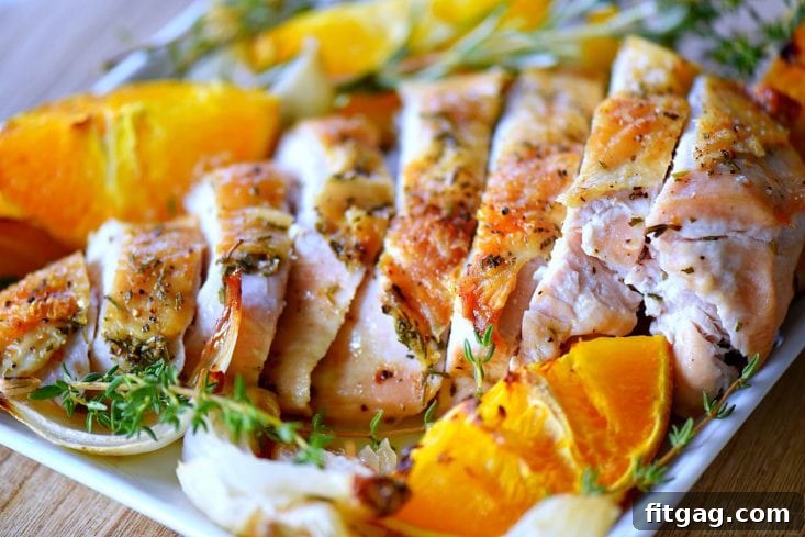 Slices of juicy roast turkey breast on a cutting board, showing its tenderness.