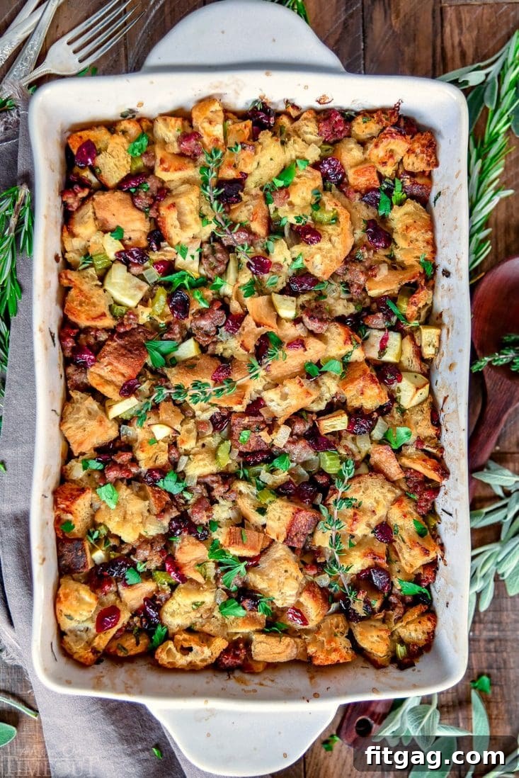 Sweet and Savory Cranberry Apple Sausage Stuffing 6 Sausage stuffing with cranberries and apples baking in a 9x13 dish, golden brown and bubbly.