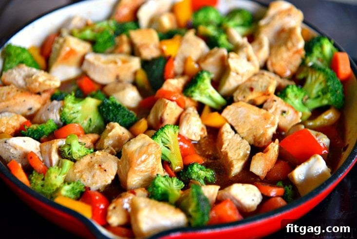 A vibrant and appetizing chicken and broccoli stir fry, glistening with a delicious sauce, perfect for a quick and healthy meal.