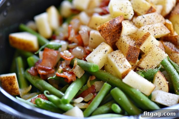 Ingredients for slow cooker green beans with bacon, including fresh green beans, sliced bacon, diced potatoes, onions, and chicken broth.