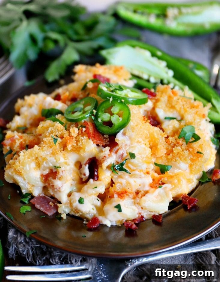 The BEST Jalapeño Popper Mac and Cheese you'll ever try! Extra creamy, loaded with bacon, cream cheese, and jalapeños, this delicious and easy mac and cheese is sure to be a new favorite! // Mom On Timeout #macandcheese #dinner #bacon #jalapeno #recipe #recipes #cheese #momontimeout jalapeno-popper-mac-and-cheese-recipe