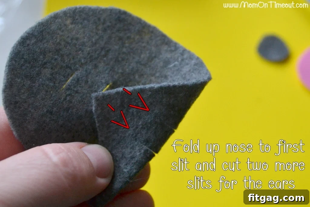 Image demonstrating how to fold the mouse's nose section and cut two additional slits for the ears.