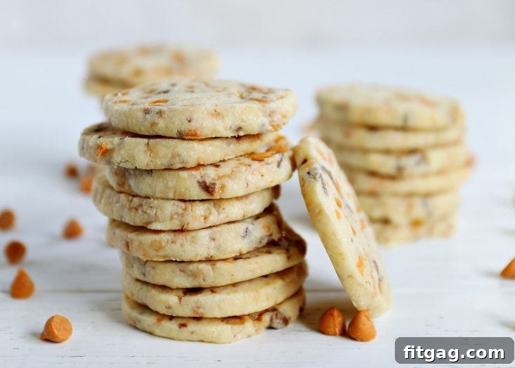 A close-up shot of the simple ingredients for butterscotch shortbread cookies laid out on a table, including flour, butter, sugar, and butterscotch chips.