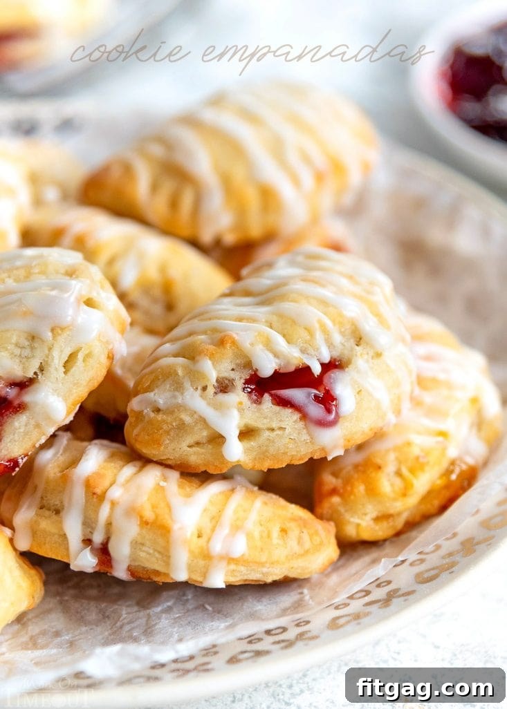 Flaky Cookie Empanadas: Perfect for Holiday Trays Delicious cookie empanadas with a variety of jam fillings, ready for holiday celebrations.