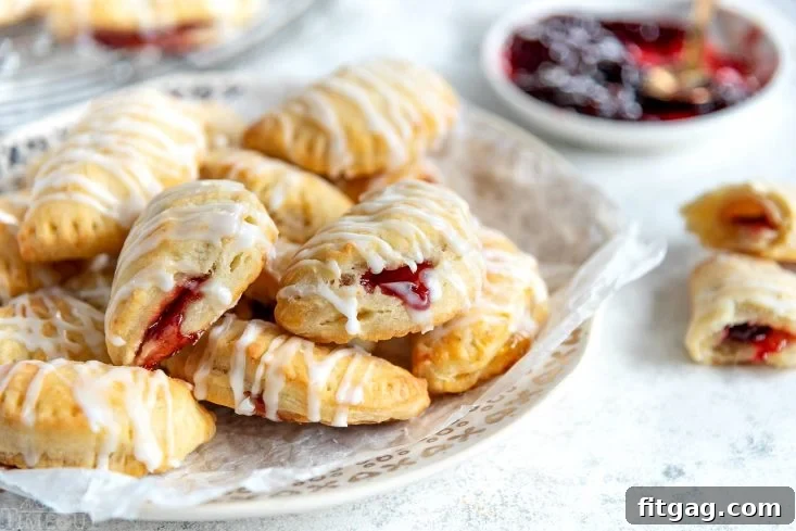 Plate of glazed cookie empanadas, ready to be served.