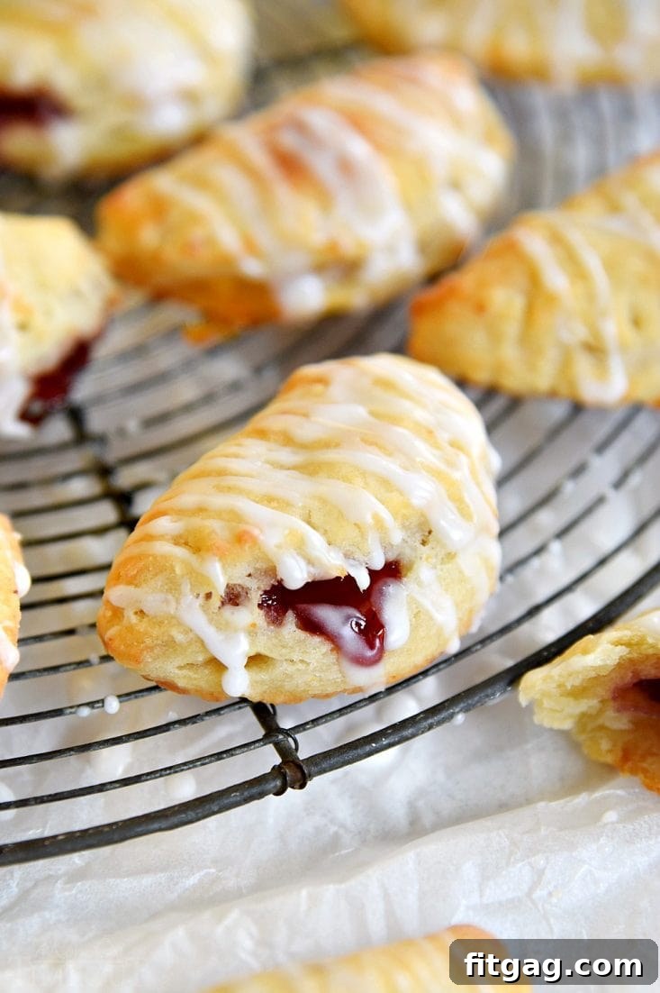 Cookie turnovers cooling on a wire rack after baking.