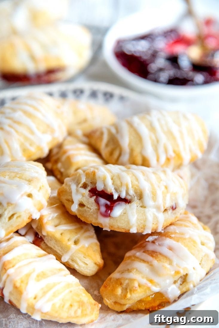 Open cookie empanada showing a vibrant raspberry filling.